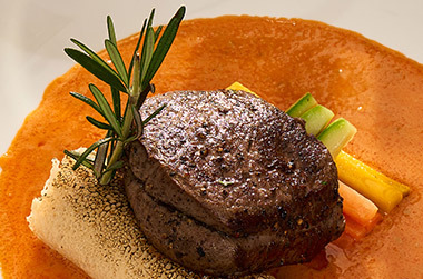 Grilled beef steak in rich orange sauce for dinner in Phuket